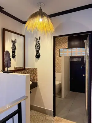 a bathroom with a zebra masks hanging on the wall at Jungle style villa 3br in Kamala Beach