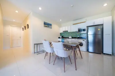 a kitchen with a table and chairs and a refrigerator at Peaceful Bliss With 120 Sqm Kamala Beach in Kathu