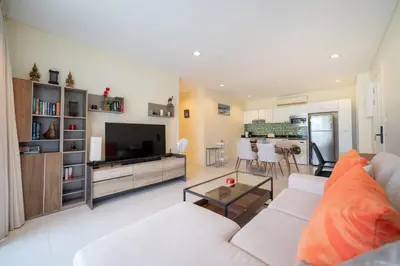 a living room with a couch and a television at Peaceful Bliss With 120 Sqm Kamala Beach in Kathu