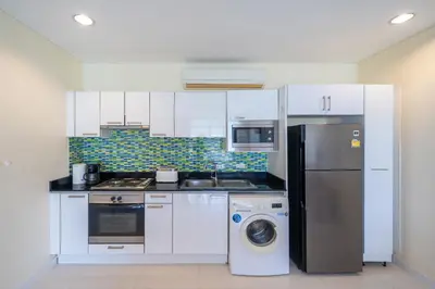 a kitchen with a refrigerator and a washing machine at Peaceful Bliss With 120 Sqm Kamala Beach in Kathu