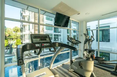 a gym with a treadmill and a large window at Peaceful Bliss With 120 Sqm Kamala Beach in Kathu