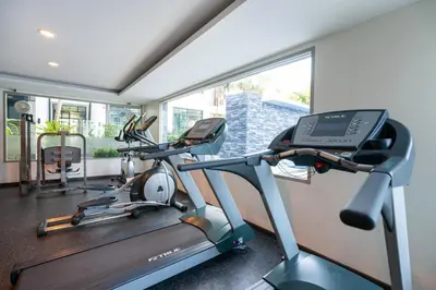 a gym with two tread machines and a window at Peaceful Bliss With 120 Sqm Kamala Beach in Kathu