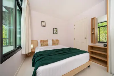 a bedroom with a large bed and a window at Peaceful Bliss With 120 Sqm Kamala Beach in Kathu