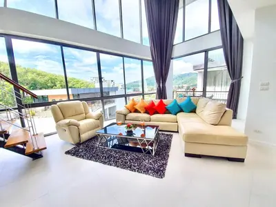 a living room with two couches and a table at Beautiful Modern Penthouse Kamala Beach in Kamala Beach