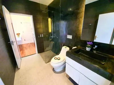 a bathroom with a toilet and a sink and a shower at Beautiful Modern Penthouse Kamala Beach in Kamala Beach