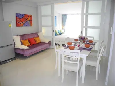 a living room with a table and a purple couch at Ideally Apartment close to Kata Beach in Kata Beach