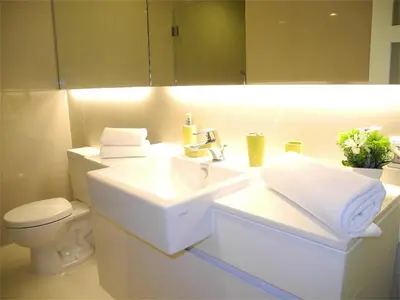 a white bathroom with a sink and a toilet at Ideally Apartment close to Kata Beach in Kata Beach