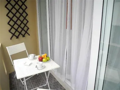 a small white table with a bowl of fruit on it at Ideally Apartment close to Kata Beach in Kata Beach