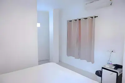 a white bathroom with a shower and a mirror at XX BAO Patong Beach Phuket - เบา ป่าตอง in Patong Beach