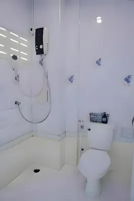 a white bathroom with a toilet and a shower at XX BAO Patong Beach Phuket - เบา ป่าตอง in Patong Beach