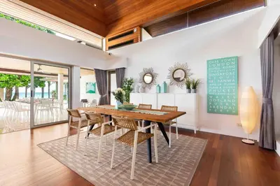a dining room with a table and chairs at Villa Sand in Pilai Beach