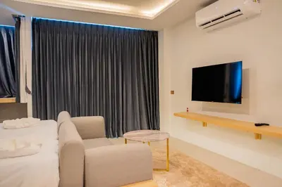 a living room with a couch and a tv at Utopia Karon in Kata Beach