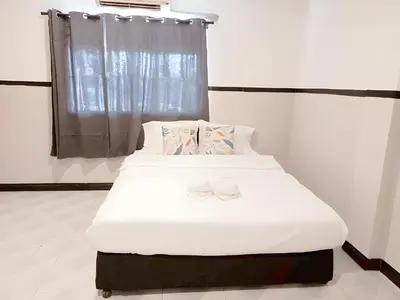a bed in a room with two shoes on it at xx Mitr INN Phuket Oldtown - มิตร ภูเก็ต in Phuket Town