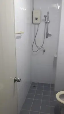 a small bathroom with a shower and a toilet at the three pyramids in Rawai Beach
