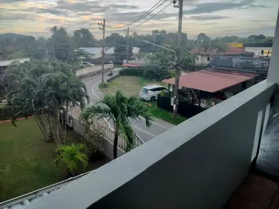 a view of a street from the balcony of a building at the three pyramids in Rawai Beach