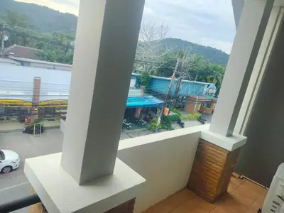 a balcony with a view of a parking lot at the three pyramids in Rawai Beach