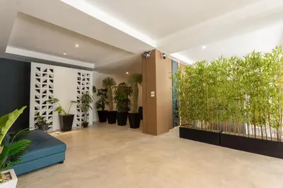 a hallway with potted plants in a building at XL PATONG Hotel in Patong Beach