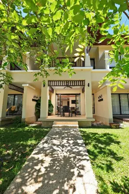 a house with a walkway in front of it at Tropical Holiday Home at Laguna Phuket in Layan Beach
