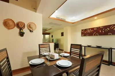 a dining room with a wooden table and chairs at Tropical Holiday Home at Laguna Phuket in Layan Beach