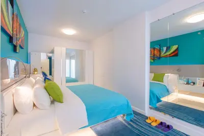 a bedroom with a bed and a large mirror at W Phuket in Phuket Town