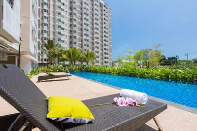a chair with flowers on it next to a swimming pool at W Phuket in Phuket Town