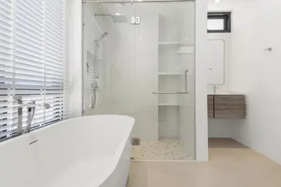 a white bathroom with a tub and a shower at Coastal Villa on Fairway in Phuket