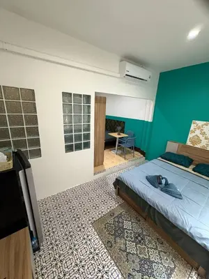 a bedroom with a bed and a tv in a room at Mamma Mia Rooms in Kata Beach