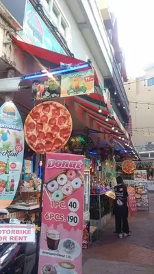a pizza shop with a large pepperoni pizza at Mamma Mia Rooms in Kata Beach