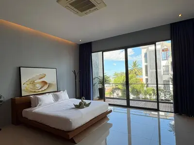a bedroom with a large bed and a swimming pool at Villa Sa in Ban Saiyuan (1)
