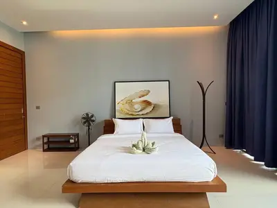 a bedroom with a bed with a plant on it at Villa Sa in Ban Saiyuan (1)