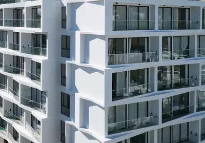 a building with balconies on the side at Laya Suites and Residences in Bang Tao Beach