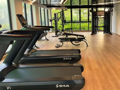 a gym with a bunch of treadmills at Laya Suites and Residences in Bang Tao Beach