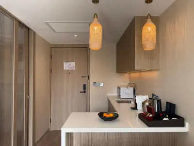 a kitchen with two pendant lights and a counter at Laya Suites and Residences in Bang Tao Beach