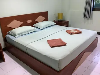 a bedroom with a large bed with two towels on it at Freedom house in Karon Beach