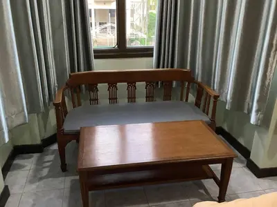 a wooden bench sitting in front of a window at Freedom house in Karon Beach