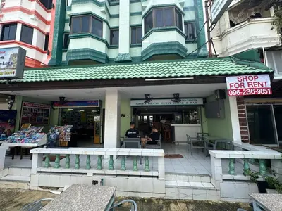 a man sitting in front of a store at Freedom house in Karon Beach