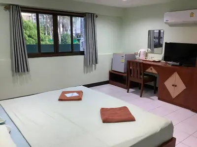 a room with a bed and a desk with a computer at Freedom house in Karon Beach