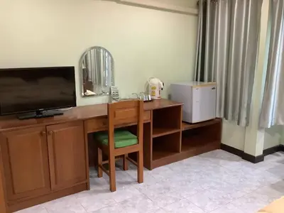 a room with a desk with a television and a mirror at Freedom house in Karon Beach