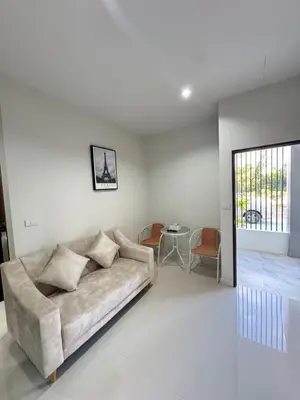 a living room with a couch and a table at Lela Home in Phuket Town