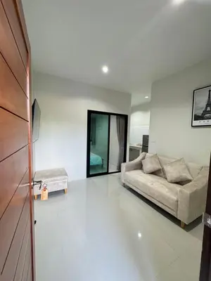 a living room with a couch and a table at Lela Home in Phuket Town