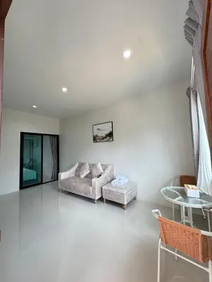 a living room with a couch and a table at Lela Home in Phuket Town
