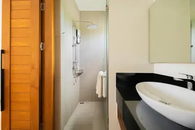 a bathroom with a white sink and a mirror at 2BR Pool Villa at Shambhala in Laguna Bangtao in Bang Tao Beach