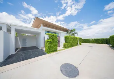 a large white house with a driveway at 2BR Pool Villa at Shambhala in Laguna Bangtao in Bang Tao Beach