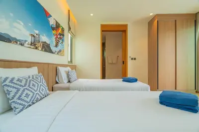 two beds in a hotel room with two beds at 2BR Pool Villa at Shambhala in Laguna Bangtao in Bang Tao Beach