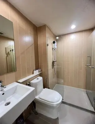 a bathroom with a toilet and a sink and a shower at Centrio condo near central Phuket in Ban Rangeng