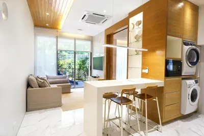a kitchen with a bar and a living room at Luxury Villa Residence near Laguna in Ban Pak Lak