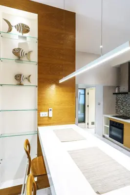 a kitchen with white walls and wood accents at Luxury Villa Residence near Laguna in Ban Pak Lak