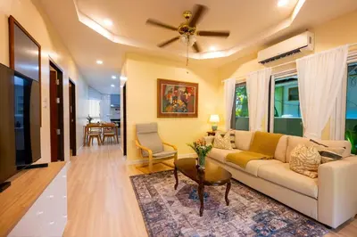 a living room with a couch and a ceiling fan at Kamala Beach House, 7-Min Walk to Beach in Kamala Beach