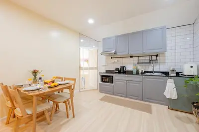 a kitchen with a table and a dining room at Kamala Beach House, 7-Min Walk to Beach in Kamala Beach