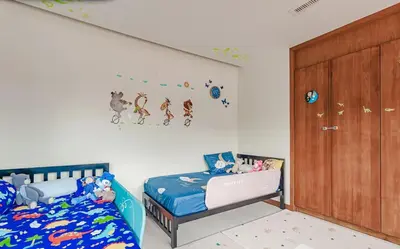 a bedroom with two beds and a wooden door at 4 BR Jacuzzi Pool Villa with Playground, near Layan, Laguna, Bang Tao beach in Ban Pak Lak